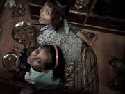 Girls eating dal bhat in their parent's shop in Kathmandu